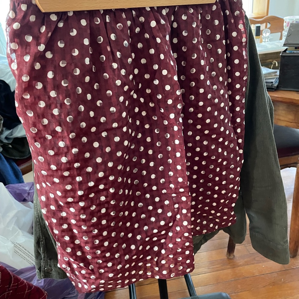 Short maroon skirt, white polka dots.